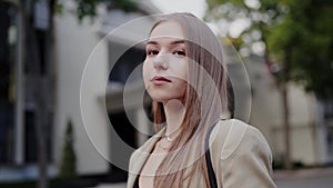 Young Woman Gazing Thoughtfully on a City Street at Dusk