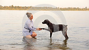 Young woman and German Shorthaired Pointer.