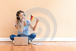 Young woman with Germany flag using a laptop computer