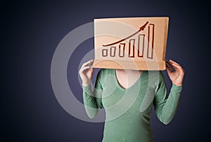 Young woman gesturing with a cardboard box on his head with diagram