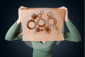 Young woman gesturing with a cardboard box on his head with spur