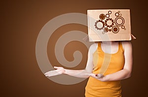 Young woman gesturing with a cardboard box on his head with spur wheels