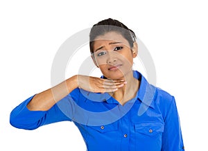 Young woman gesturing with hand to stop talking, cut it out