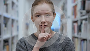 Young Woman Gesturing Silence, Finger on Lips, Indoor