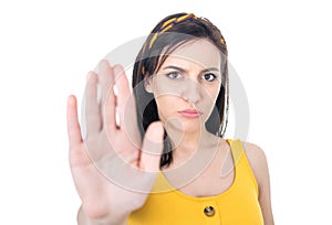 Young woman gesturing stop sign with palm of hand,refuses or reject something, isolated on white background