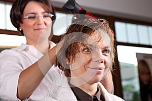 Young woman gets a hairdo in the beauty-