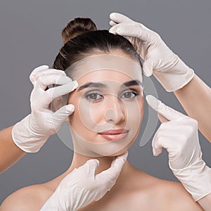 Young woman getting consultation at plastic surgery clinic