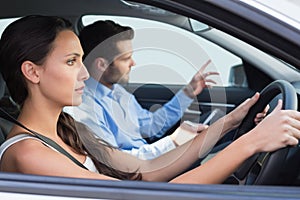 Young woman getting a driving lesson