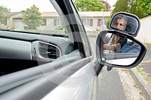 Young woman getting driving lesson in car