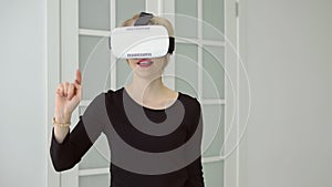 Young woman getting experience using VR headset glasses of virtual reality at home much gesticulating hands