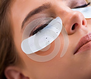 Young woman getting eyelash extension