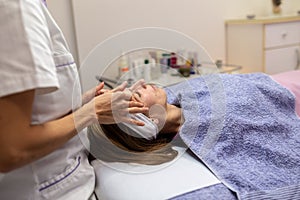 Young woman getting a facial massage