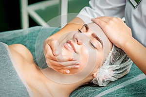 Young woman getting facial massage