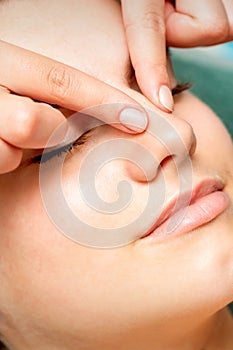 Young woman getting facial massage