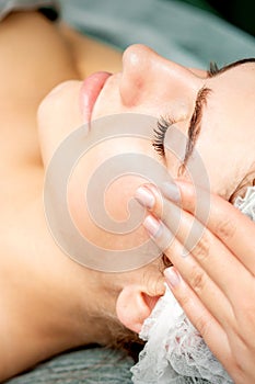 Young woman getting facial massage