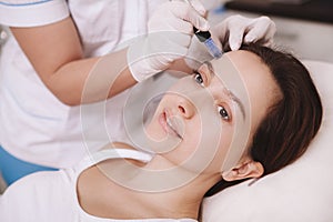 Young woman getting facial skincare treatment photo