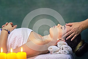 Young woman getting head massage at luxury spa