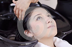 Young woman getting her hair washed