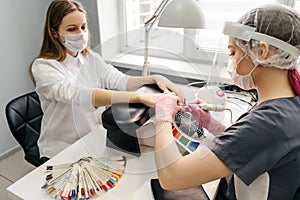 Young woman getting manicure in beauty salon