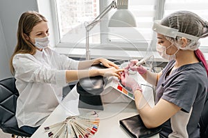 Young woman getting manicure in beauty salon