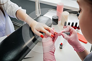 Young woman getting manicure in beauty salon