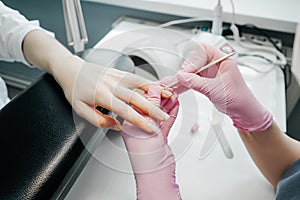 Young woman getting manicure in beauty salon