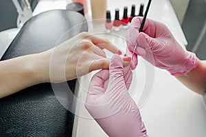 Young woman getting manicure in beauty salon