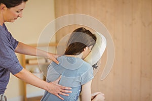 Young woman getting massage in chair