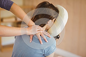 Young woman getting massage in chair