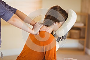 Young woman getting massage in chair