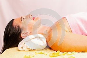 Young woman getting a massage at the spa. A woman enjoys a relaxing back massage in a beauty spa. Body care, skin care