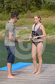 Young woman getting pre checked before water skiing lesson