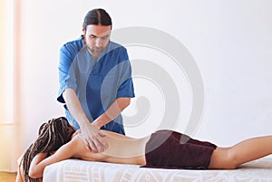 Young woman getting spa massage treatment at beauty spa salon