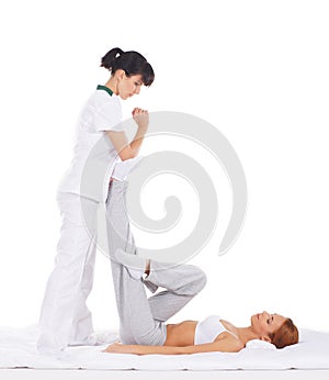 A young woman getting a traditional Thai massage