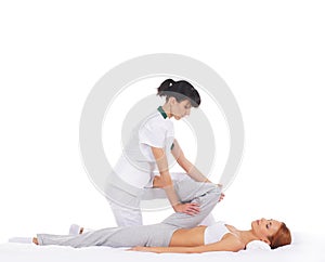 A young woman getting a traditional Thai massage