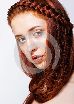 Young woman with ginger braids hairdo on white background