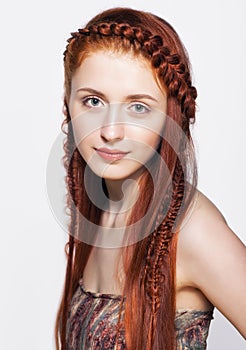 Young woman with ginger braids hairdo on white background