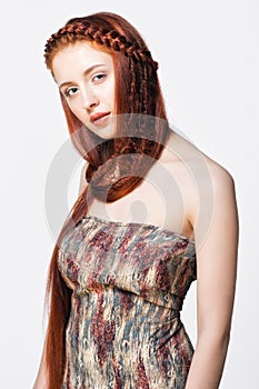 Young woman with ginger braids hairdo on white background