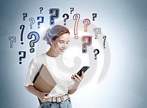 Young woman girl in casual clothes with phone and notes over grey wall with question marks