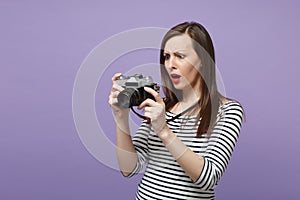 Young woman girl in casual striped clothes posing isolated on violet purple background studio portrait. People sincere