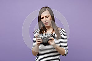 Young woman girl in casual striped clothes posing isolated on violet purple background studio portrait. People sincere