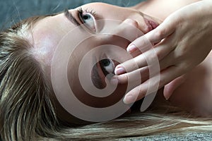 Young woman girl putting contact lens in her eye