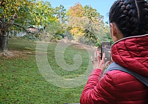 young woman girl taking photo smartphone tourist social media zoo Wild animal