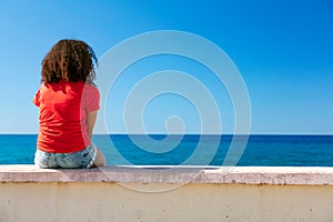 Young Woman Girl Teenager Sitting Wall Looking to Sea