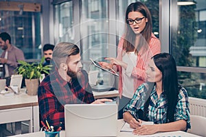 Young woman giving advices to executive managers about project