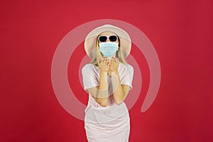 Young woman giving an air kiss with face mask