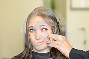 Young woman giving the hairdresser a dubious look