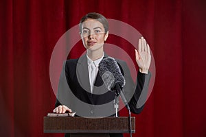 Young Woman Giving Oath on Stage