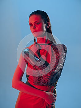 young woman Glamor posing red light metal armor on hand Lifestyle unaltered