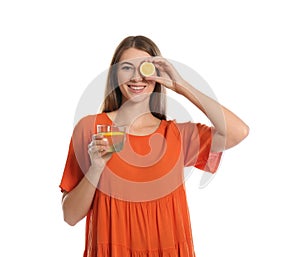 Young woman with glass of lemon water on background